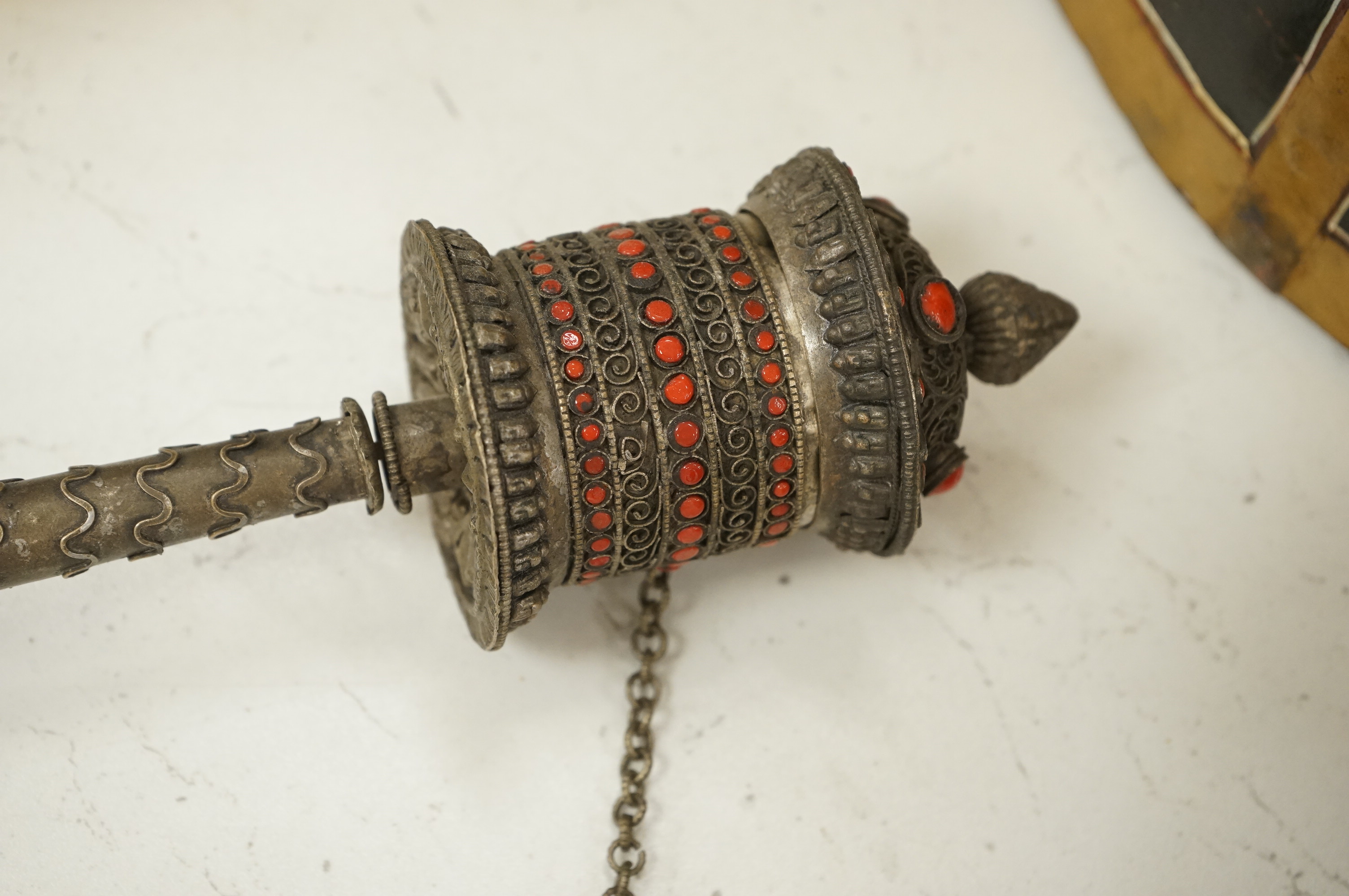 A collection of tribal and Asian collectables including a Tibetan prayer wheel, carvings, etc.
